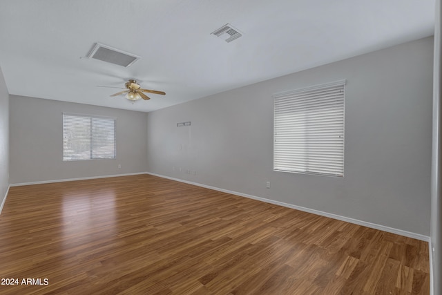 empty room featuring ceiling fan and hardwood / wood-style flooring