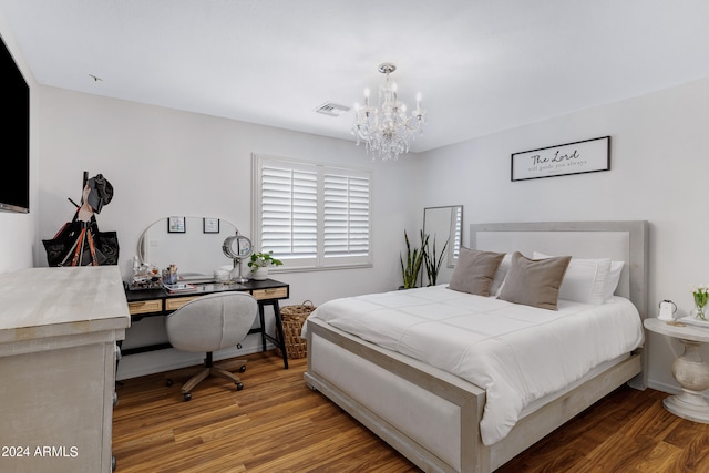 bedroom featuring wood-type flooring and a chandelier