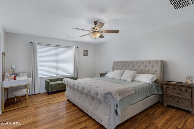 bedroom with ceiling fan and dark hardwood / wood-style flooring