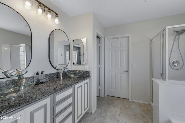 bathroom featuring vanity, tile patterned flooring, and a shower with shower door