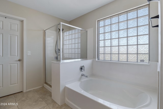 bathroom featuring tile patterned flooring and plus walk in shower