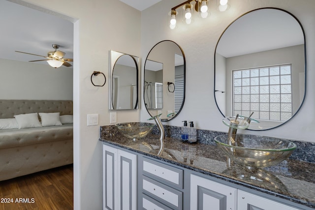 7715 S 69th Ln, Laveen, AZ 85339 - ensuite bathroom with double vanity, ceiling fan, a sink, and wood finished floors