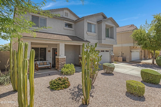 7715 S 69th Ln, Laveen, AZ 85339 - view of front of house featuring a tile roof, stucco siding, a garage, and driveway