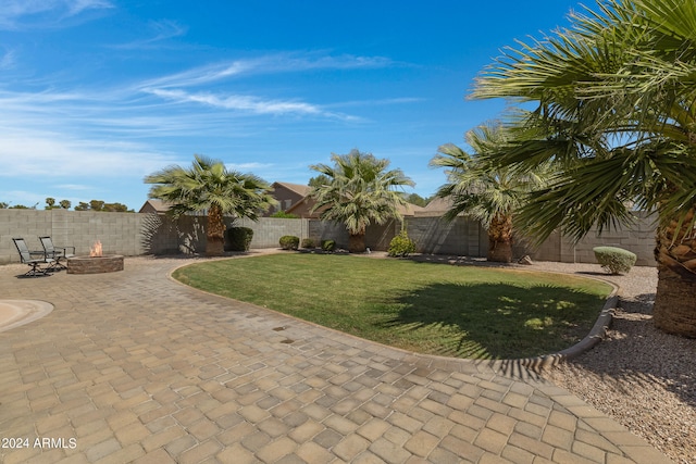 view of yard featuring a patio and a fire pit