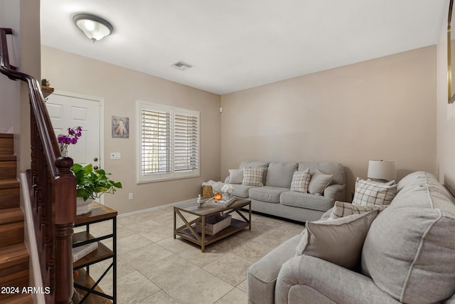 7715 S 69th Ln, Laveen, AZ 85339 - living area featuring light tile patterned flooring, stairs, visible vents, and baseboards