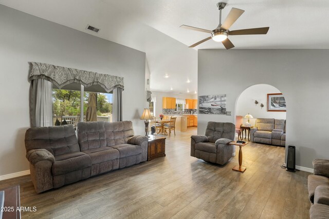 111 S Forest Park Dr, Payson, AZ 85541 - living room featuring a ceiling fan, visible vents, high vaulted ceiling, arched walkways, and light wood finished floors
