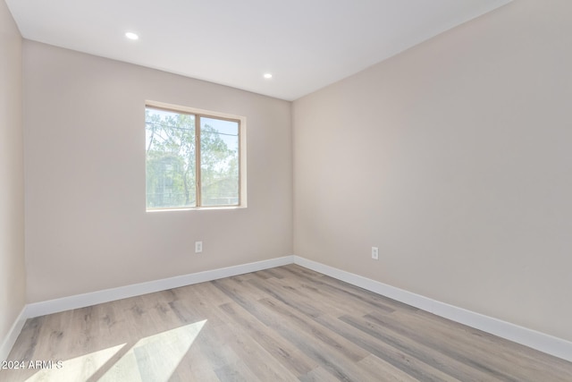 unfurnished room with light wood-type flooring