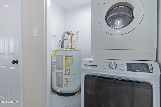 washroom featuring stacked washing maching and dryer and electric water heater