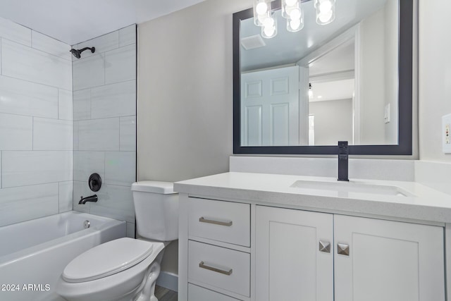 full bathroom with vanity, tiled shower / bath combo, and toilet