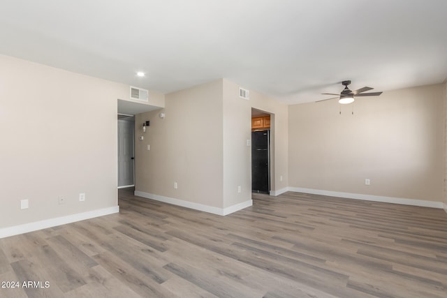 spare room featuring light hardwood / wood-style floors and ceiling fan