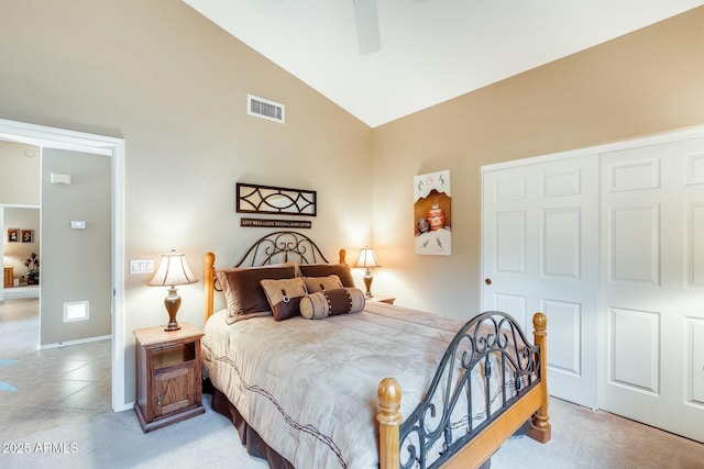 bedroom with a ceiling fan, visible vents, vaulted ceiling, baseboards, and a closet