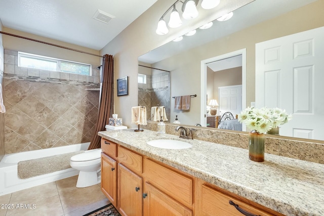 ensuite bathroom with ensuite bathroom, tile patterned flooring, toilet, vanity, and shower / bathtub combination with curtain