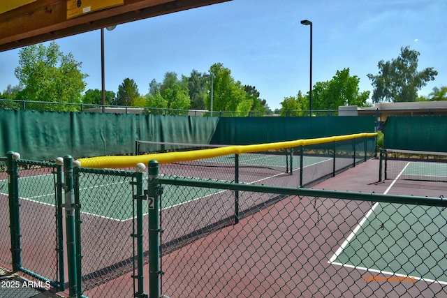 view of sport court with fence