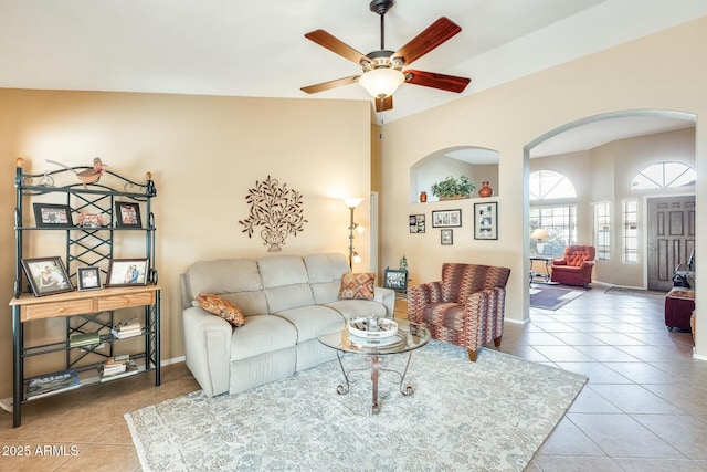 tiled living room featuring ceiling fan