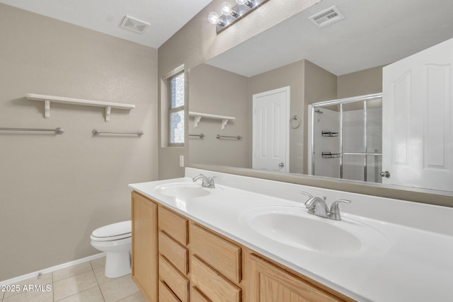 bathroom featuring toilet, tile patterned flooring, walk in shower, and vanity