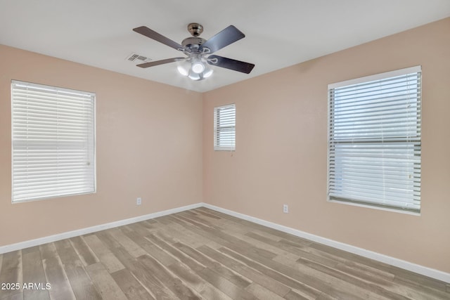 spare room with ceiling fan and light hardwood / wood-style floors