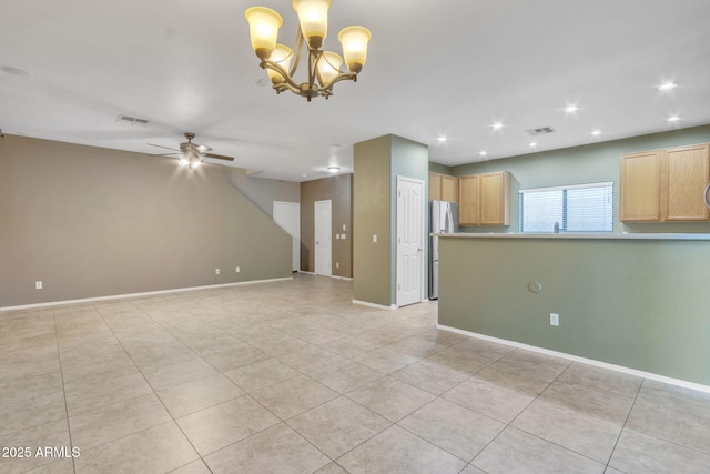 interior space featuring ceiling fan with notable chandelier and light tile patterned flooring