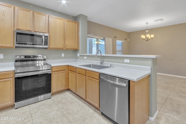 kitchen featuring kitchen peninsula, stainless steel appliances, light brown cabinets, and sink