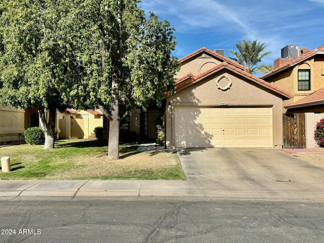 view of front of home with a garage and a front yard