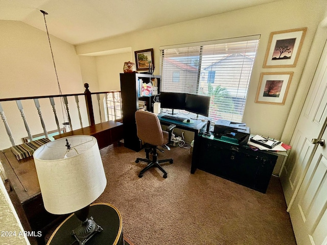 carpeted home office featuring lofted ceiling