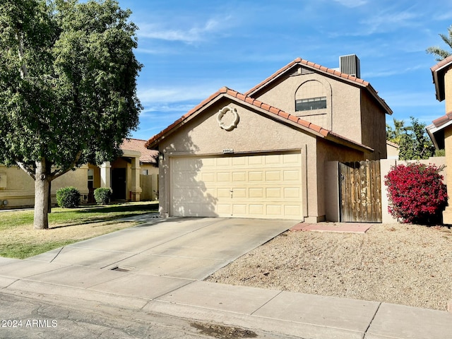 view of front of home featuring cooling unit and a garage