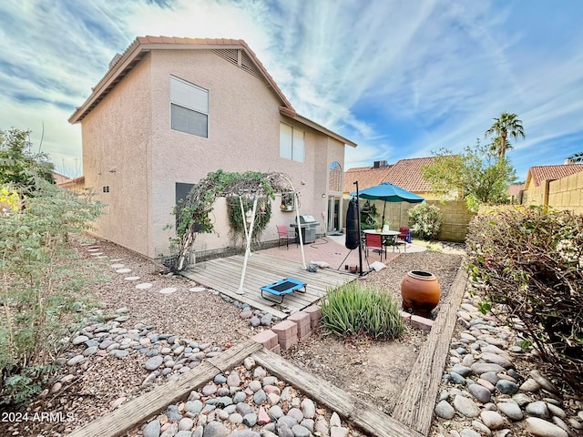 back of house with a wooden deck