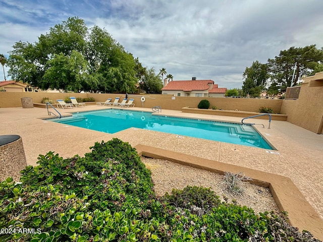 view of swimming pool featuring a patio area