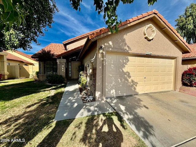 view of front of property with a garage and a front yard