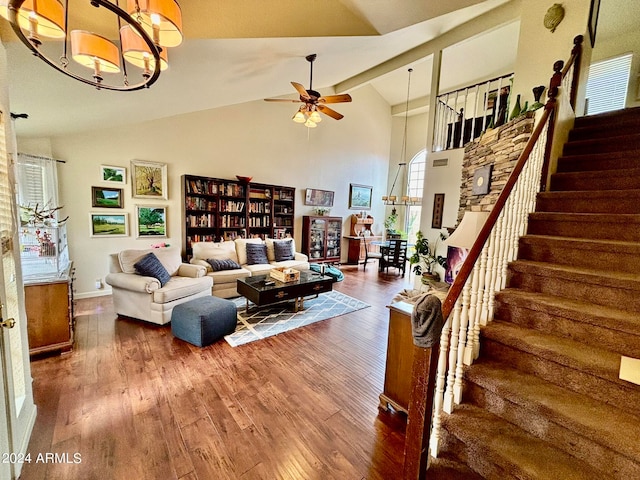 living room featuring ceiling fan with notable chandelier, dark hardwood / wood-style flooring, high vaulted ceiling, and beamed ceiling