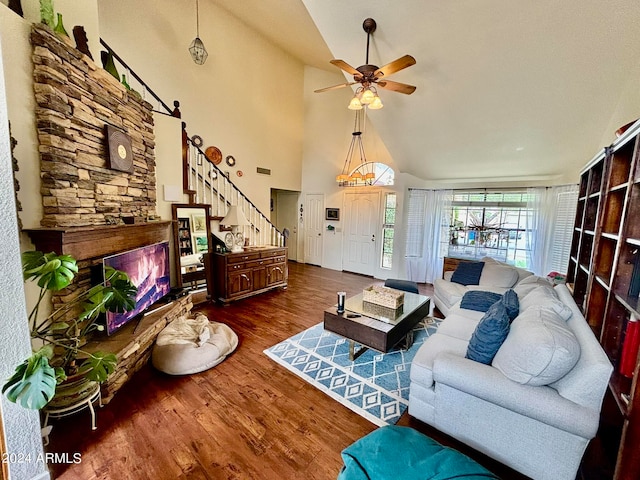 living room with dark hardwood / wood-style floors, ceiling fan, and high vaulted ceiling