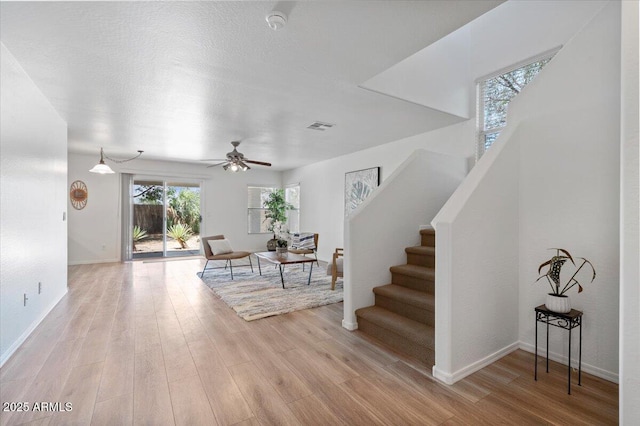 180 S 18th St, Coolidge, AZ 85128 - entryway featuring light wood finished floors, stairs, a ceiling fan, and baseboards