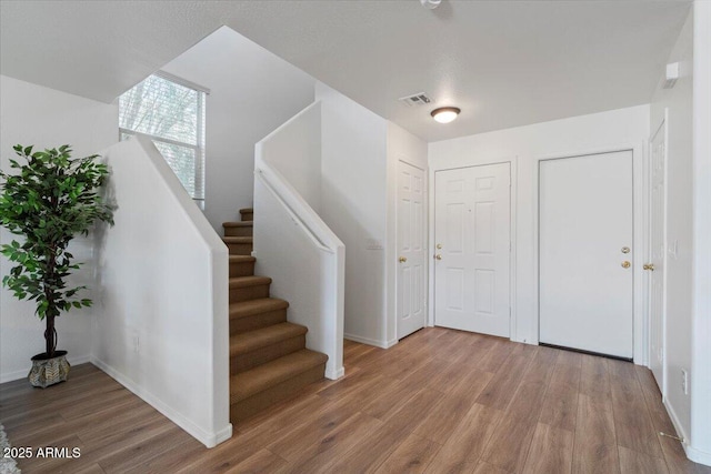 180 S 18th St, Coolidge, AZ 85128 - entrance foyer featuring wood finished floors, baseboards, and stairway