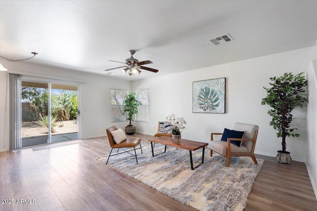 180 S 18th St, Coolidge, AZ 85128 - living area with wood finished floors, a ceiling fan, and baseboards