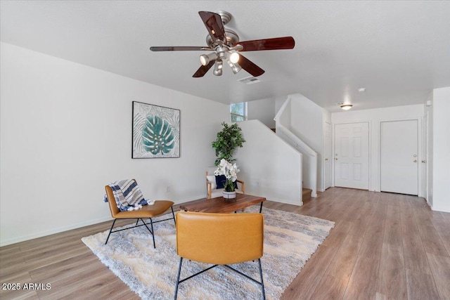 180 S 18th St, Coolidge, AZ 85128 - sitting room with wood finished floors, a ceiling fan, stairs, and baseboards