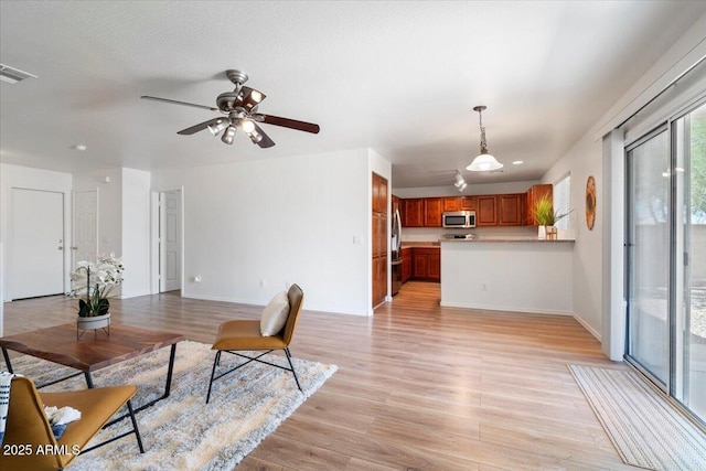 180 S 18th St, Coolidge, AZ 85128 - living area with light wood-style floors, ceiling fan, and baseboards