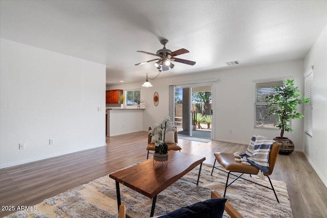 180 S 18th St, Coolidge, AZ 85128 - living area with ceiling fan, light wood-style floors, and baseboards