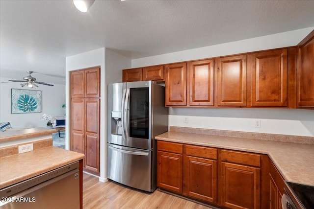 180 S 18th St, Coolidge, AZ 85128 - kitchen featuring stainless steel fridge with ice dispenser, brown cabinets, light countertops, and light wood-type flooring
