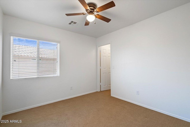 180 S 18th St, Coolidge, AZ 85128 - spare room featuring light colored carpet, baseboards, and ceiling fan