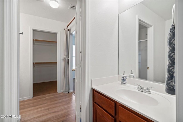 180 S 18th St, Coolidge, AZ 85128 - bathroom featuring wood finished floors, vanity, and baseboards