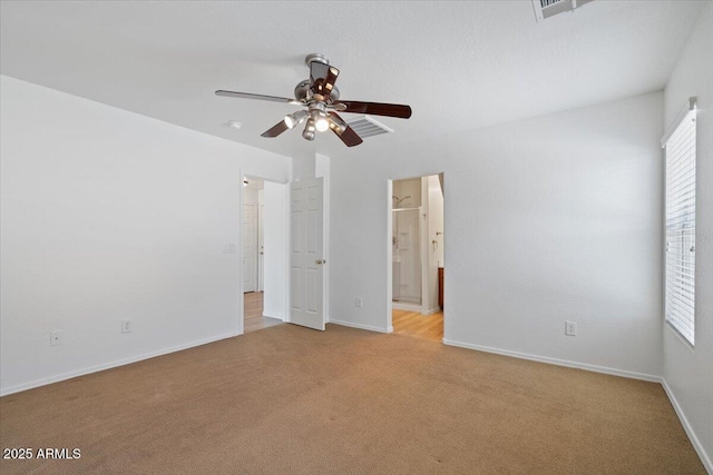 180 S 18th St, Coolidge, AZ 85128 - unfurnished bedroom featuring light carpet, baseboards, ensuite bath, and a ceiling fan