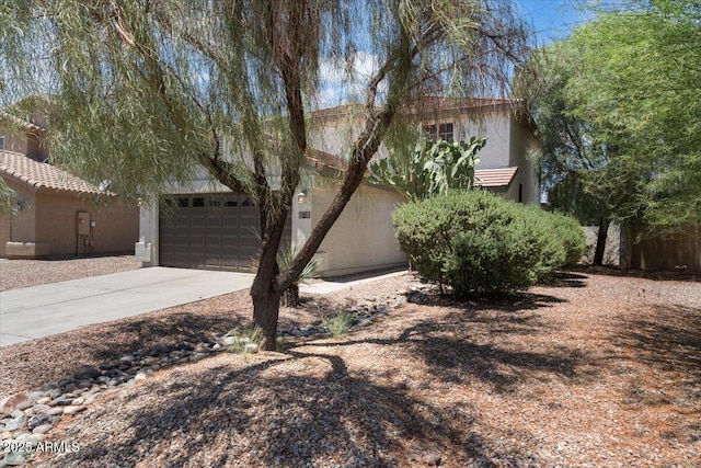 180 S 18th St, Coolidge, AZ 85128 - view of property hidden behind natural elements featuring stucco siding, driveway, and a garage