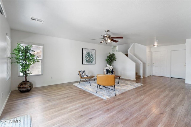 180 S 18th St, Coolidge, AZ 85128 - sitting room featuring light wood-style flooring, a ceiling fan, stairs, and baseboards