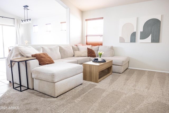 living room with carpet floors, plenty of natural light, and baseboards