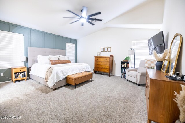 bedroom with lofted ceiling, ceiling fan, and light colored carpet