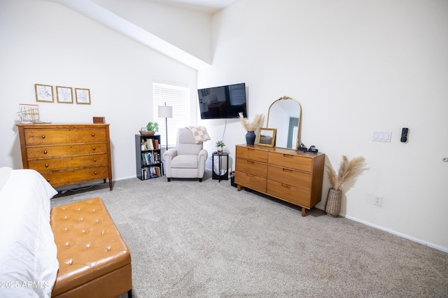 bedroom with a towering ceiling, baseboards, and light colored carpet