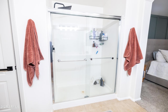 bathroom featuring a shower stall, connected bathroom, and tile patterned floors