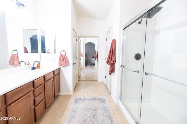 full bath featuring a stall shower, vanity, and tile patterned floors