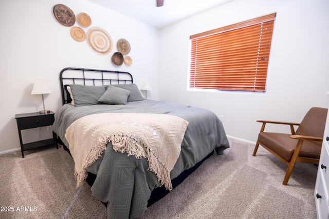 carpeted bedroom featuring baseboards and a ceiling fan