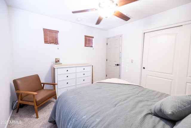 carpeted bedroom with a closet and ceiling fan