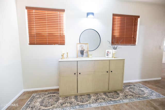 bathroom with vanity, baseboards, and tile patterned floors